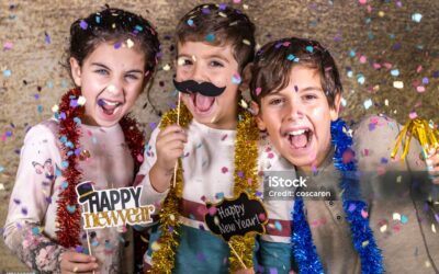 Thre happy kids celebrating new year eve at home