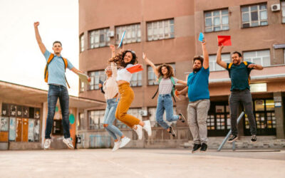zakonczenie roku szkolnego Group of friends jumping of joy on the university campus after passing the test.